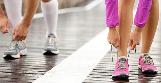 legând șireturile de pantofi înainte de a face jogging pentru pierderea în greutate